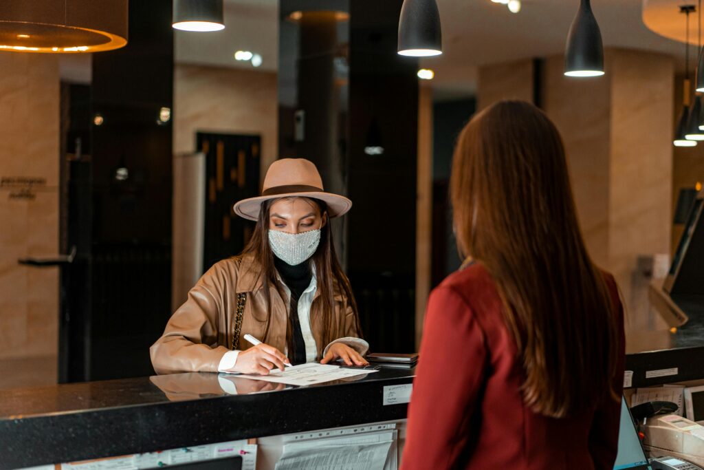 Hotel receptionist assisting guest at front desk in Dubai
